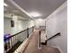 Hallway featuring detailed trim, a crystal chandelier, and wrought iron railing at 552 Warrenton Run Dr, Sugar Hill, GA 30518