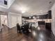 Open-concept kitchen featuring dark cabinets, island with seating and a chandelier at 552 Warrenton Run Dr, Sugar Hill, GA 30518