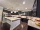 Gourmet kitchen features stainless steel appliances, granite countertops, custom cabinets and center island at 552 Warrenton Run Dr, Sugar Hill, GA 30518