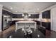 Open concept kitchen features dark cabinets, granite counters and stainless steel appliances at 552 Warrenton Run Dr, Sugar Hill, GA 30518