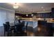 Large kitchen with granite countertops, dark wood cabinets, stainless steel appliances, and a center island at 552 Warrenton Run Dr, Sugar Hill, GA 30518