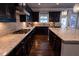 Modern kitchen with granite countertops, dark cabinets, backsplash, and a center island with storage at 552 Warrenton Run Dr, Sugar Hill, GA 30518