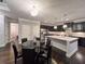 Gourmet kitchen showcases black cabinetry, stainless steel appliances, and center island at 552 Warrenton Run Dr, Sugar Hill, GA 30518