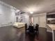 Open living area with hardwood floors, elegant light fixtures, and contemporary furnishings at 552 Warrenton Run Dr, Sugar Hill, GA 30518