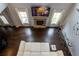 Grand living room boasts hardwood floors, fireplace, and modern decor, viewed from above at 552 Warrenton Run Dr, Sugar Hill, GA 30518