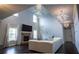 Grand living room with high ceilings, fireplace, and modern chandeliers, creating an elegant and inviting space at 552 Warrenton Run Dr, Sugar Hill, GA 30518