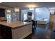 Open concept layout with kitchen island, dining area, and living room with fireplace and high ceilings at 552 Warrenton Run Dr, Sugar Hill, GA 30518