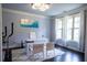 Well-lit office with large windows, a modern desk setup, and sleek decor for a productive atmosphere at 552 Warrenton Run Dr, Sugar Hill, GA 30518