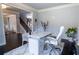 Bright home office with a white desk, chair, and exercise equipment, offering a functional workspace at 552 Warrenton Run Dr, Sugar Hill, GA 30518