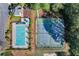 Aerial view of community pool, playground, and tennis courts nestled among mature trees at 1035 Bridle Path Dr, Lawrenceville, GA 30045