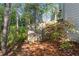 Side yard with lush foliage and access gate at 1035 Bridle Path Dr, Lawrenceville, GA 30045