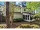 Two-story home with screened porch and flowering shrubs at 1035 Bridle Path Dr, Lawrenceville, GA 30045