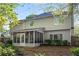 View of backyard featuring a screened porch and lush landscaping at 1035 Bridle Path Dr, Lawrenceville, GA 30045