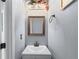 Cozy powder room features a modern vanity, framed mirror with decorative lighting, and fresh paint at 1035 Bridle Path Dr, Lawrenceville, GA 30045