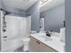 Cozy bathroom featuring a vanity, toilet, and tub with a showerhead; neutral paint and tile flooring throughout at 1035 Bridle Path Dr, Lawrenceville, GA 30045