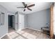 Comfortable bedroom with a ceiling fan, ample natural light, neutral paint, and carpeted flooring; ample natural light at 1035 Bridle Path Dr, Lawrenceville, GA 30045