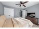Bedroom boasts double closets, natural light, ceiling fan, and neutral walls complemented by earth-toned bedding at 1035 Bridle Path Dr, Lawrenceville, GA 30045