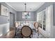 Formal dining room with chandelier, wood floors, and large windows at 1035 Bridle Path Dr, Lawrenceville, GA 30045