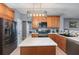 Modern kitchen features stainless steel appliances, wooden cabinetry, island with quartz countertop, and stylish lighting at 1035 Bridle Path Dr, Lawrenceville, GA 30045
