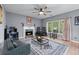 Comfortable living room with fireplace, ceiling fan, and ample natural light at 1035 Bridle Path Dr, Lawrenceville, GA 30045
