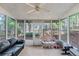 Cozy sunroom surrounded by many windows offering natural light; the space is furnished with wicker and leather furniture at 1035 Bridle Path Dr, Lawrenceville, GA 30045