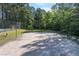 Sand volleyball court surrounded by green grass and shady trees, great for outdoor fun at 1035 Bridle Path Dr, Lawrenceville, GA 30045