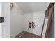 Bright walk-in closet featuring neutral carpeting, shelving, clothing rod, and white painted door and walls at 1035 Bridle Path Dr, Lawrenceville, GA 30045