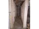 Basement hallway showcasing framed walls and dirt flooring, an opportunity to create extra storage or living areas at 110 Dahlia Nw Ave, Atlanta, GA 30314