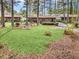 Spacious backyard with lush lawn, mature trees, and a patio area perfect for outdoor entertaining at 1868 Fort Valley Sw Dr, Atlanta, GA 30311