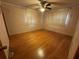Bedroom with hardwood floors, fan and light at 1868 Fort Valley Sw Dr, Atlanta, GA 30311