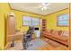 Inviting bedroom with windows, ceiling fan, and a comfortable seating area at 1868 Fort Valley Sw Dr, Atlanta, GA 30311
