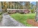Charming brick home boasts a well-manicured lawn and a long driveway leading to the front entrance at 1868 Fort Valley Sw Dr, Atlanta, GA 30311