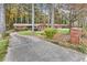 Beautiful brick home nestled among tall trees, featuring a lush lawn and inviting curb appeal at 1868 Fort Valley Sw Dr, Atlanta, GA 30311