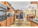Spacious kitchen features black appliances, wooden cabinets, and a tiled floor with room for dining at 1868 Fort Valley Sw Dr, Atlanta, GA 30311
