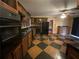 Spacious kitchen features black appliances, wooden cabinets, and a tiled floor with room for dining at 1868 Fort Valley Sw Dr, Atlanta, GA 30311
