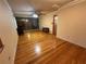 Spacious living room features hardwood floors, ceiling fan, and decorative wall paneling at 1868 Fort Valley Sw Dr, Atlanta, GA 30311