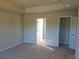 Bright bedroom with carpeted floors, neutral paint, and a doorway to the en suite bath at 233 Bloomfield Cir, Canton, GA 30114