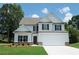 Charming two-story home with a manicured lawn, attached garage, and classic design at 233 Bloomfield Cir, Canton, GA 30114
