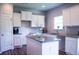 Well-lit kitchen boasts granite counters, island, ample cabinetry, and stainless steel sink at 233 Bloomfield Cir, Canton, GA 30114
