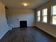 Spacious living room featuring a fireplace, large windows, and hardwood floors at 233 Bloomfield Cir, Canton, GA 30114