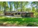Beautiful backyard featuring a deck, screened in porch, and a well-manicured lawn at 2799 Briarglen Dr, Atlanta, GA 30340