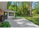 Spacious backyard featuring a walkway leading to the home, with mature trees offering shade at 2799 Briarglen Dr, Atlanta, GA 30340