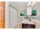 Neutral bathroom featuring white fixtures and a shower curtain at 2799 Briarglen Dr, Atlanta, GA 30340