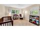 Bright Bedroom with wood crib, rocker, changing table, and built-in bookcase at 2799 Briarglen Dr, Atlanta, GA 30340
