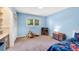 Playful bedroom with a bright blue wall, toys, and a cozy carpet at 2799 Briarglen Dr, Atlanta, GA 30340