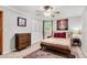 Neutral bedroom featuring a ceiling fan, double door closet and warm carpet at 2799 Briarglen Dr, Atlanta, GA 30340