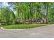 View of the property's exterior showing the large front lawn and mature trees at 2799 Briarglen Dr, Atlanta, GA 30340