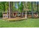 Charming single-story brick home featuring a red front door and mature trees in a landscaped yard at 2799 Briarglen Dr, Atlanta, GA 30340