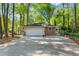 Spacious two-car garage with a basketball hoop, driveway, and adjacent brick exterior wall at 2799 Briarglen Dr, Atlanta, GA 30340