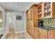 Kitchen featuring wooden cabinets, stone backsplash, and stainless steel appliances at 2799 Briarglen Dr, Atlanta, GA 30340